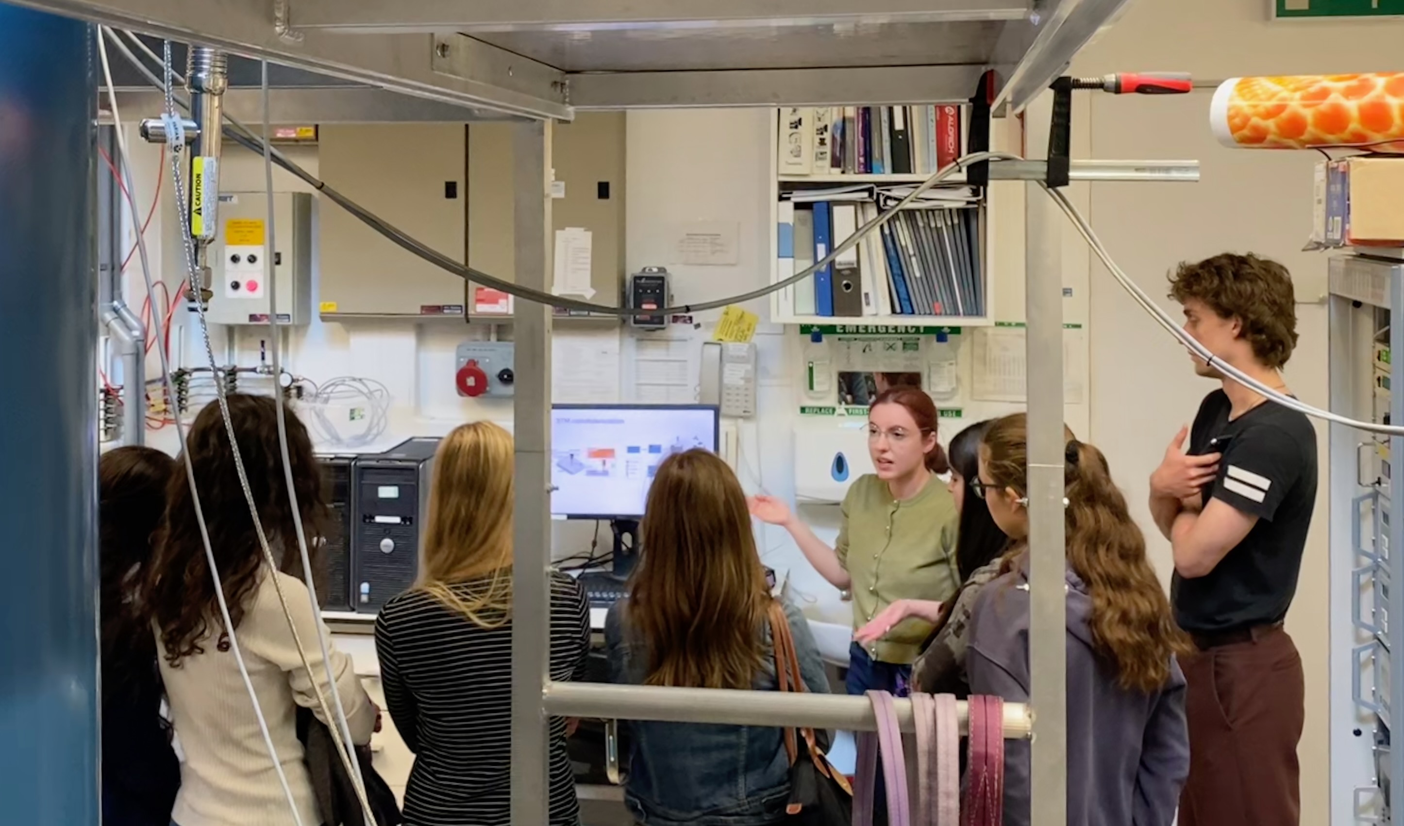 Georgia presenting her atom manipulation research to visiting students in the STM laboratory